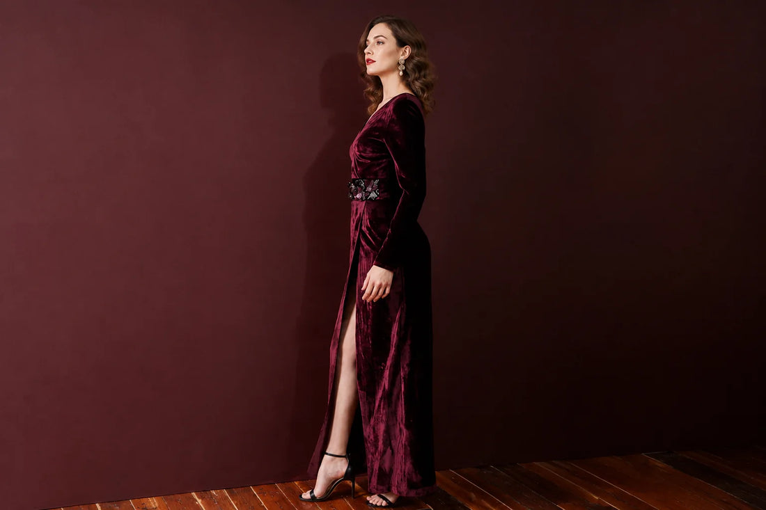 Woman wearing a burgundy velvet floor-length evening gown for a black-tie event
