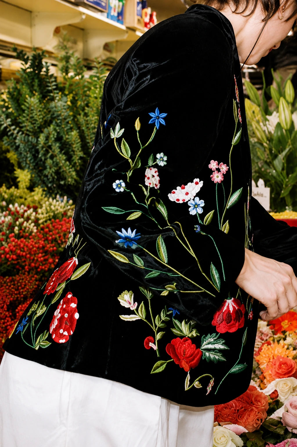 Close-up of colorful floral hand embroidery on black silk velvet of the Lavanya Coodly Bethany jacket