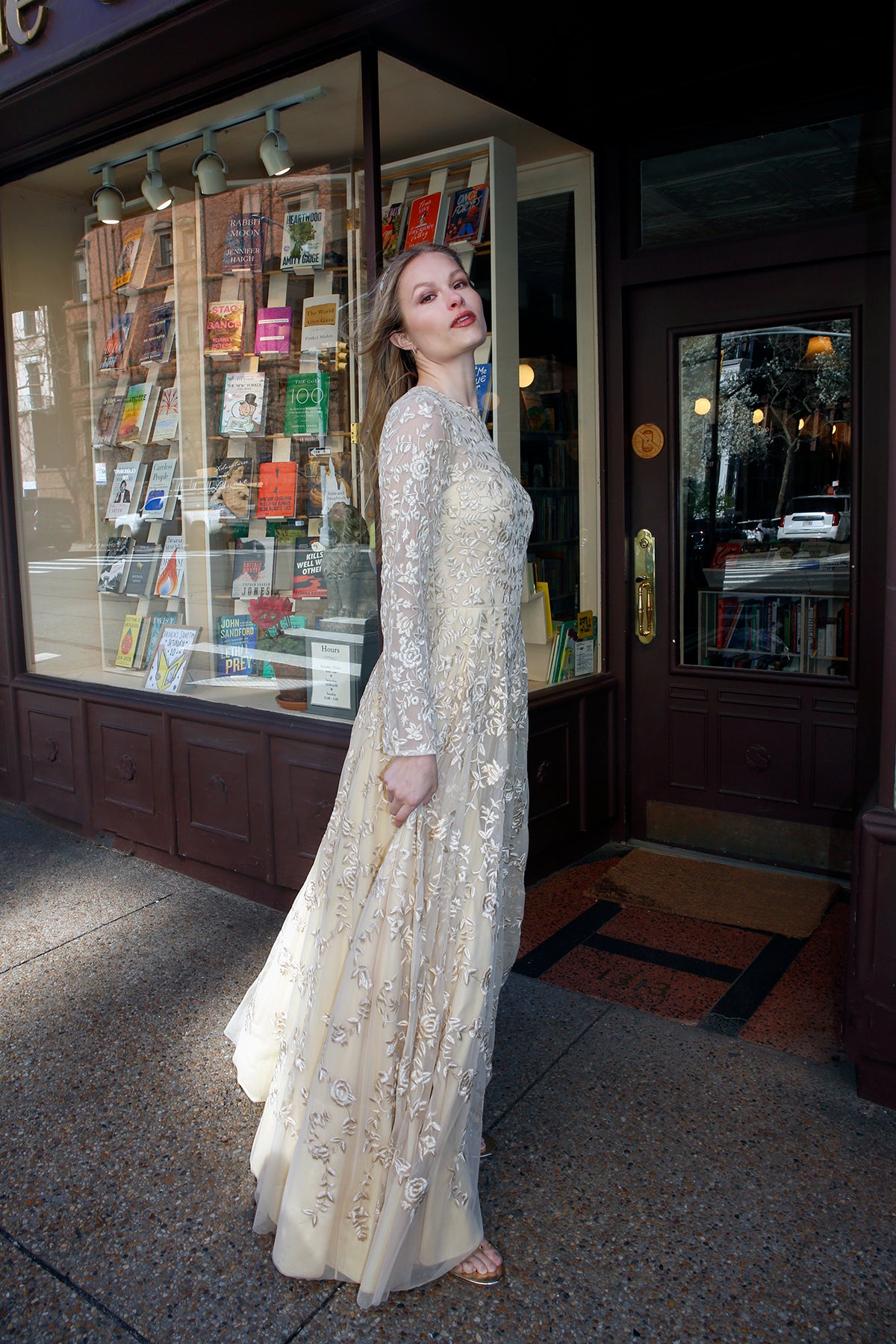 Model wearing Lavanya Coodly's Olympia hand-embroidered evening gown, featuring a pale gold tulle fit-and-flare silhouette and full-length sheer sleeves.