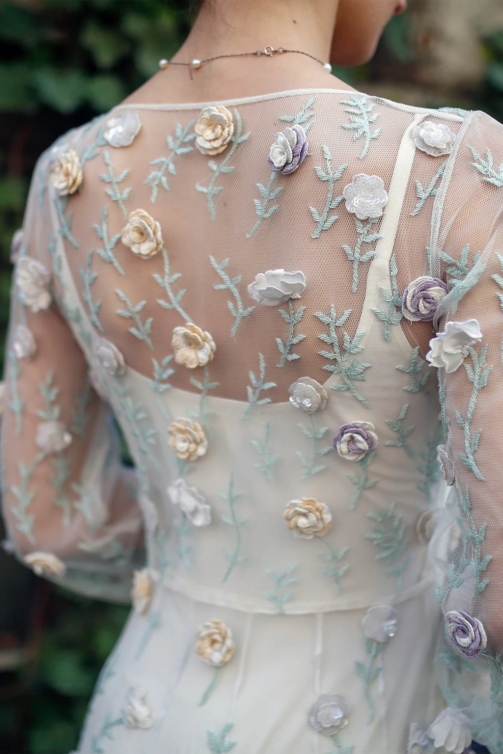 Detail of Rosalind gown by Lavanya Coodly showing 3D floral appliqués and embroidered sheer tulle